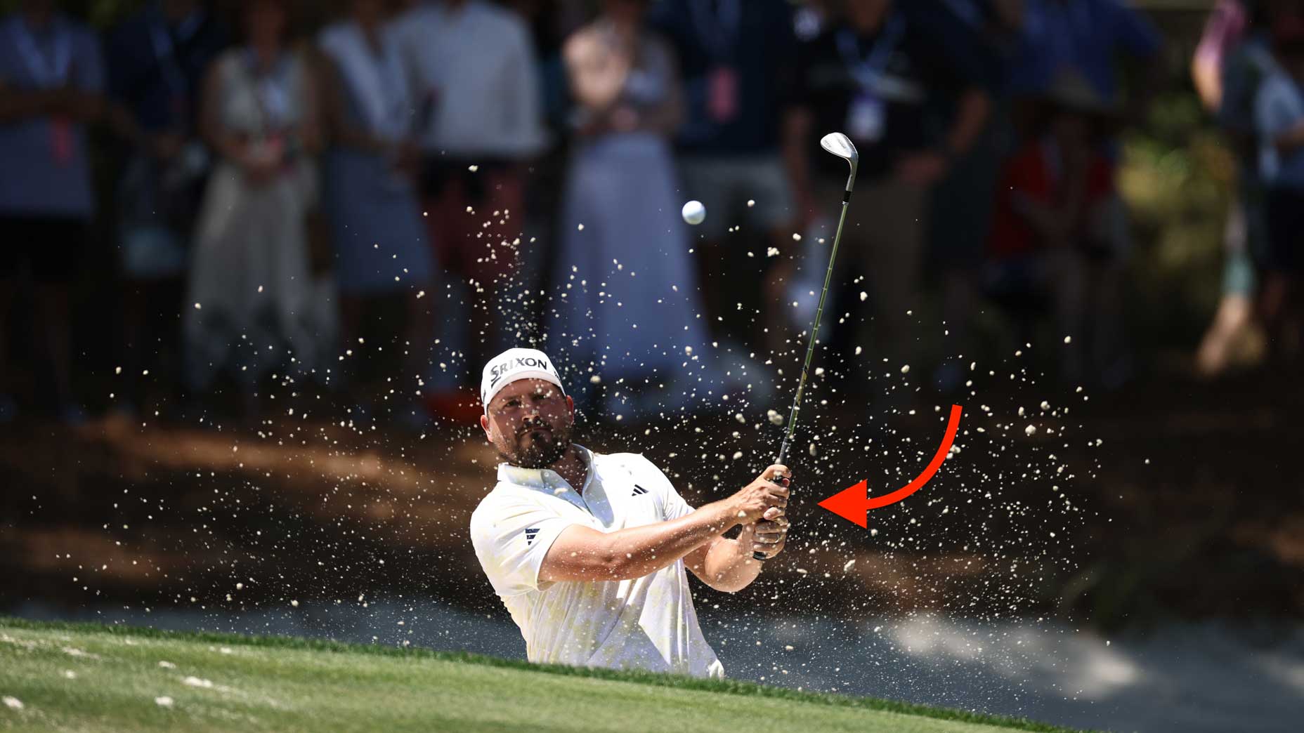 Andrew Novak plays a shot from a bunker