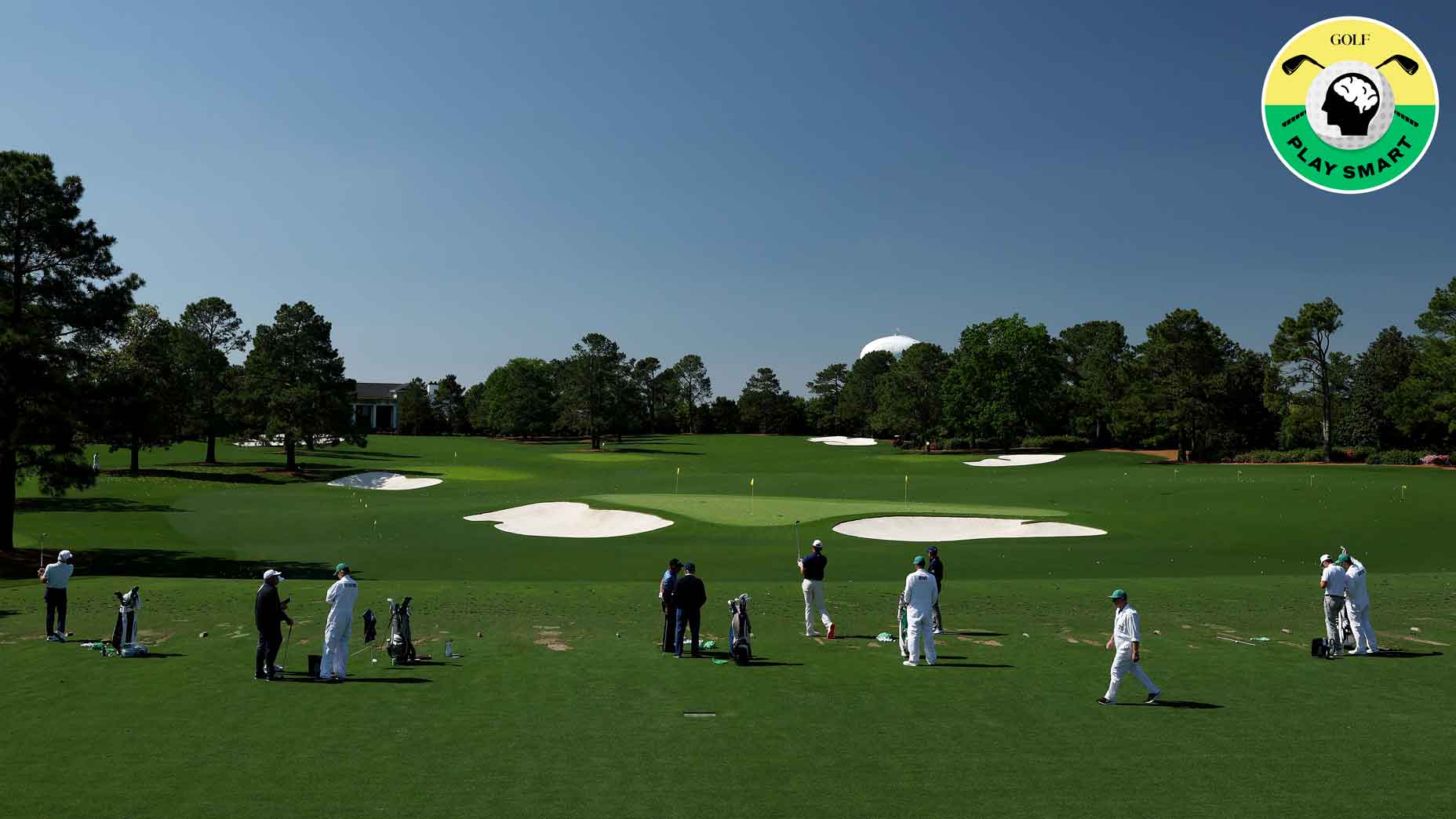 players hit balls on the range ahead of the 2025 masters