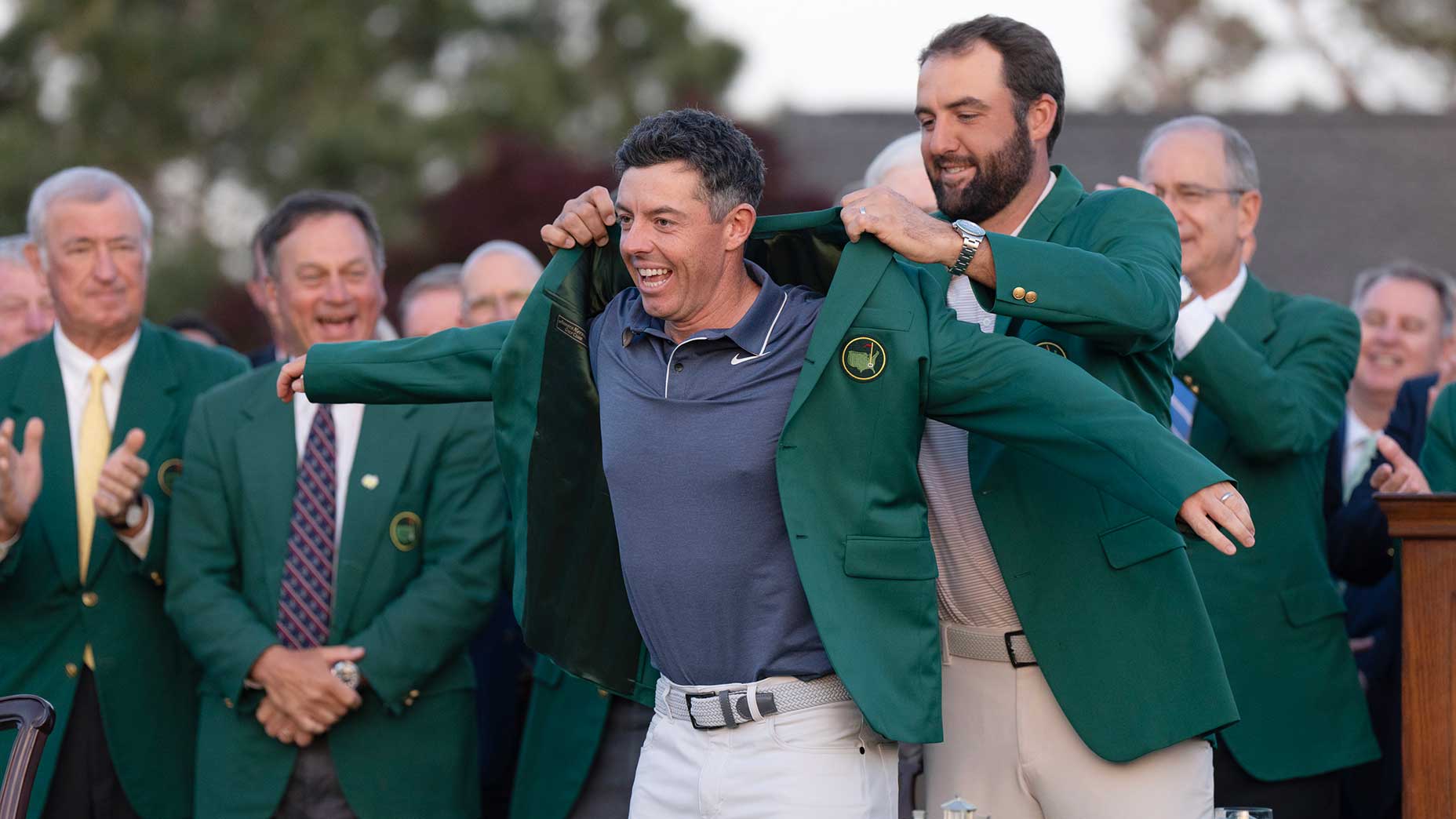 scottie scheffler puts a green jacket on rory mcilroy